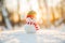 Snowman in winter wonderland scene. Christmas, New Year postcard design. Wintertime magic. Snowman in december snow at sunset