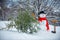 Snowman Woodcutter with axe in the winter forest. SnowMan is going to cut a christmas tree. Snowman with freshly cut