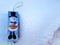 Snowman wooden puzzle ornament on a thick layer of snow