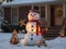 snowman in yard of haus decorated for Christmas