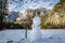 Snowman at Yosemite Valley during winter with Upper Yosemite Falls on background - Yosemite National Park, California, USA
