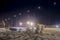 Snowmans family at december night under road lights