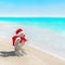 Snowmen couple at sea beach in christmas hat. New years holiday