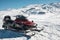 Snowmobile against snow covered slope at background