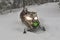 Snowmobile at high speed while it is snowing in the pine forest