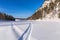 Snowmobile track on frozen mountain river