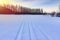 Snowmobile track in snowlandscape. Winter time background