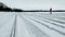 Snowmobile Tracks on Lake in Snow, Boy Standing