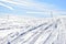 Snowmobile tracks under a blue sky