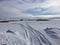 Snowmobile tracks in the vast winter landscape of Fort Chipewyan, Alberta, Canada.