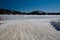 Snowmobile trail that ends on a large frozen lake