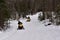 Snowmobiles riding on forest trail in the Adirondacks