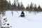 Snowmobiling in deep powder in the forrest