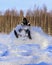 Snowmobiling in deep powder and jumping