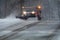 Snowplow in action clearing residential roads during snow storm