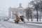 Snowplow cleans from the road snow near the entrance to VDNKh in Moscow