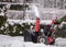 Snowplow cleans tracks in a snowy park on a cloudy winter day