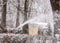 Snowplow cleans tracks in a snowy park on a cloudy winter day