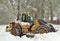 Snowplow Clearing a Residential Road in a Heavy Snowstorm