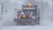Snowplow plowing a main road during a blizzard in low visability