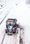 Snowplow removing the Snow from the Highway during a Snowstorm