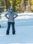 Snowshoeing Woman Looks At Camera with Hands On Hips