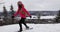 Snowshoeing woman in winter forest hiking in idyllic winter landscape. People on hike in snow in snowshoes living active