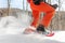 Snowshoes walking in snow. Closeup of legs of man athlete running in white deep powder snow snowshoeing wearing snowshoe