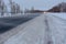 Snowstorm on the highway. Patterns on the winter highway in the form of four straight lines.