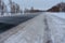 Snowstorm on the highway. Patterns on the winter highway in the form of four straight lines. Snowy road