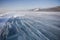 Snowstorm on ice of Lake Baikal. Winter landscape