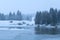 Snowstorm over lake in Alps