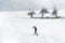 Snowstorm scenery. Man walking through snowfall. Winter weather