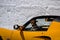 Snowwalls with yellow sportscar on the Hochalpenstrasse in spring