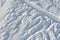 Snowy abstract off-piste skiing backround with ski and snowboard trails and tracks on new virgin powder snow. morning sunrise or