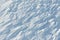 Snowy abstract off-piste skiing backround with ski and snowboard trails and tracks on new virgin powder snow. morning sunrise or