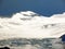 Snowy alpine peak Titlis with the eponymous glacier Titlis-Gletscher over the Engelbergertal valley and in the Uri Alps massif