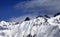 Snowy avalanches mountainside at sunny day