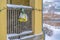 Snowy balcony with colorful lights and bells