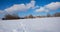 Snowy bavarian winter landscape with traditional church, blue sky with clouds