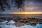 Snowy beach in Gdynia Orlowo at sunrise, Baltic Sea. Poland