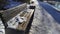 Snowy bench in winter covered with snow in a frosty December and cold winter from January to February with blizzards and snowfall