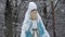 Snowy blessed Virgin Mary sculpture in cemetery