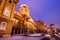 Snowy Buda Castle in Budapest under a purplish blue sky