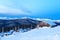 Snowy cabin in the winter mountains