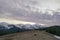 A snowy Carpathian mountain range with a violet sky and clouds in the background, Chornohora