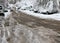 Snowy cars travels on a very icy road with uncleaned snow and snowdrifts during snowfall in the winter in Sofia, Bulgaria - Jan 2,