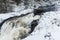 Snowy cascade waterfall landscape. Kivach Falls, Karelia