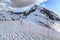 Snowy Caucasus mountain peak winter scenery with footprints on the snow on the top of Aibga ridge in Sochi