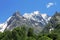 Snowy caucasus mountains and green forest